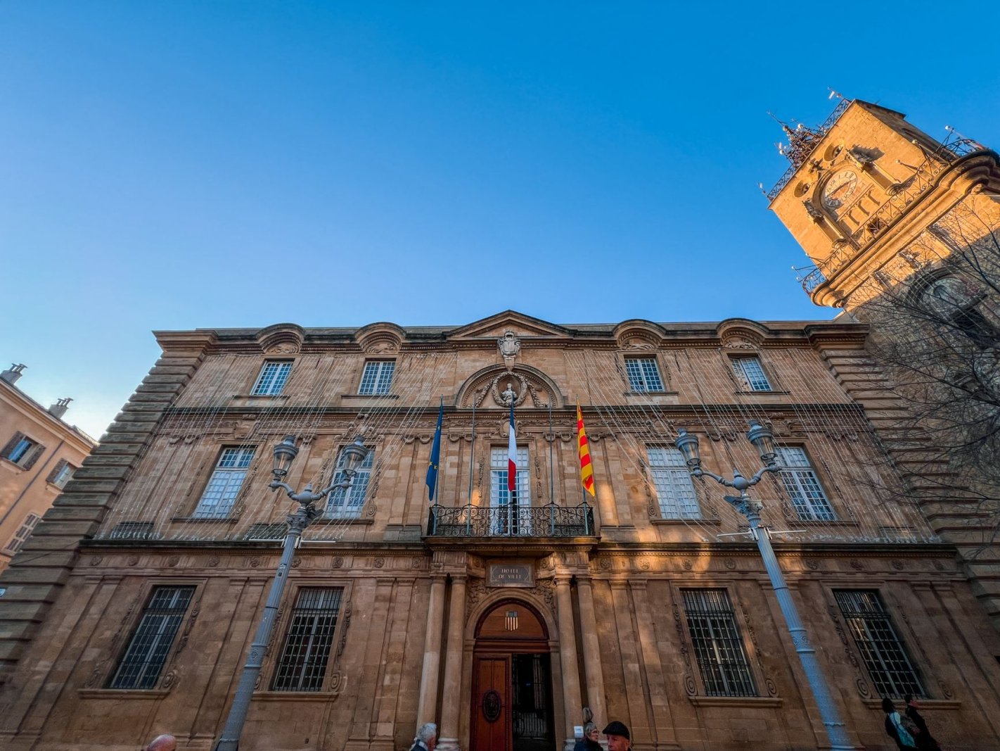 Stunning architecture of a historic building in Aix-en-Provence under a clear blue sky.